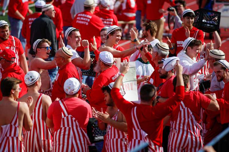 a group of people in red and white striped shirts