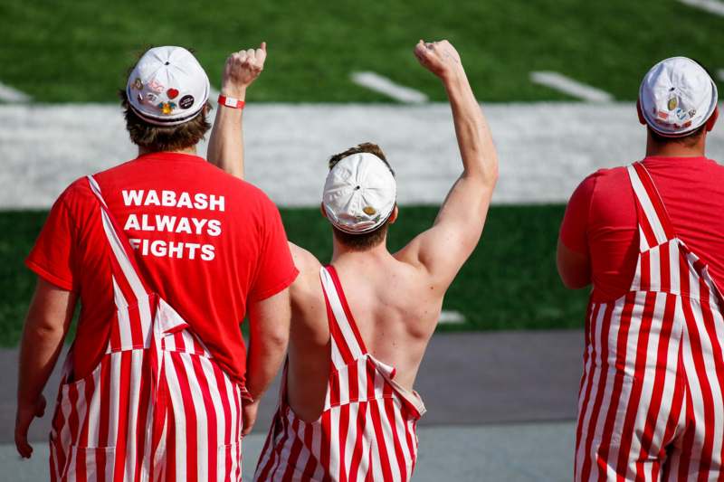 a group of men wearing red and white striped overalls
