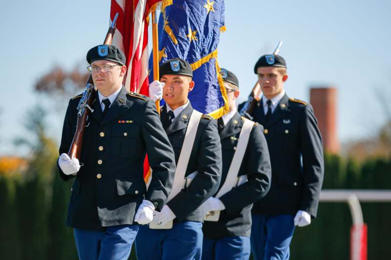 a group of people in uniform holding flags