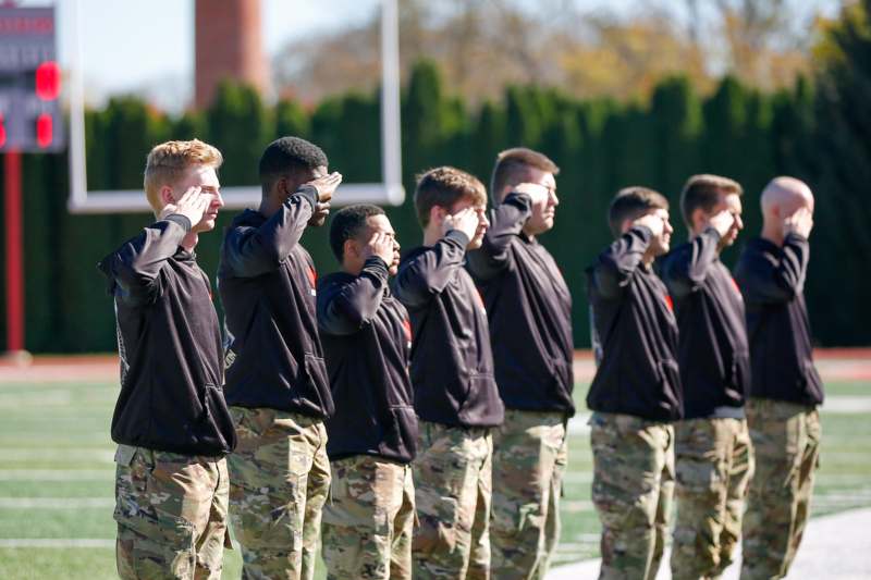 a group of men saluting