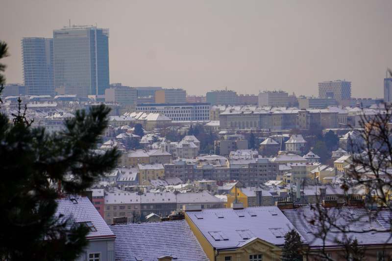 a city with snow on rooftops