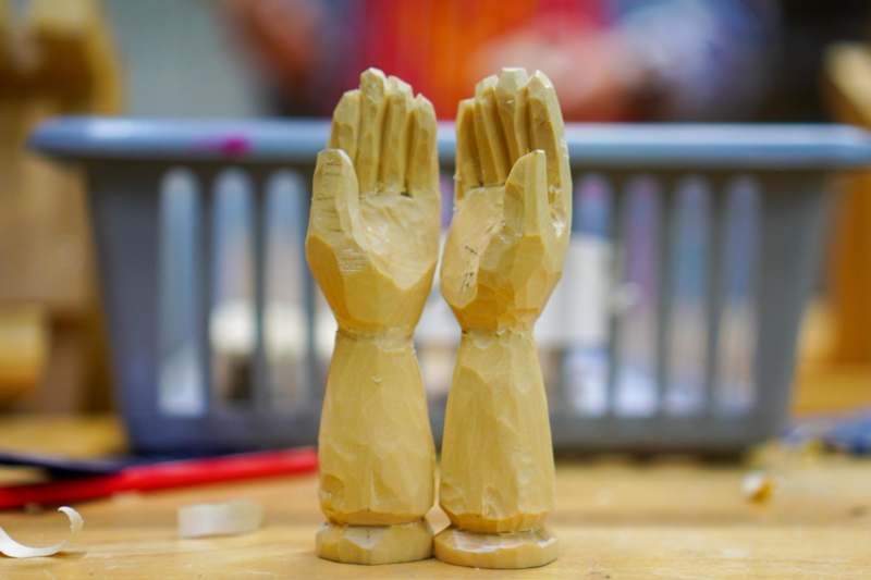 a wooden hands on a table