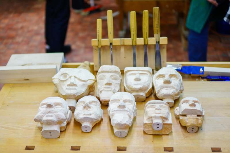 a group of carved heads on a table