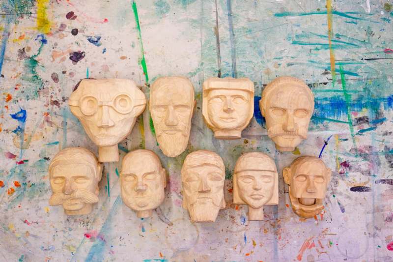 a group of carved wooden heads
