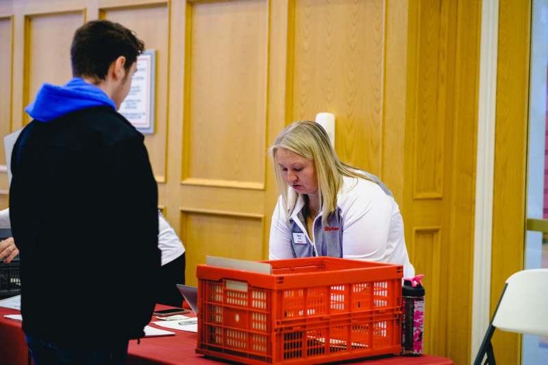 a woman looking at a red crate