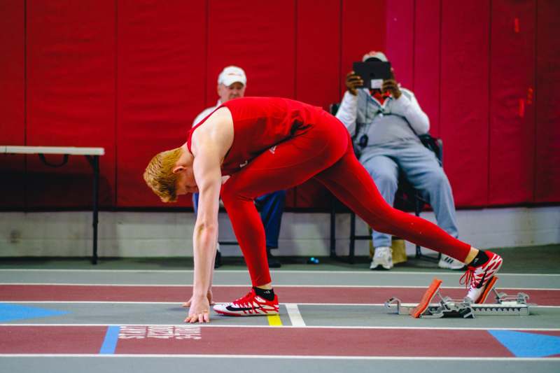 a man in red uniform on a track