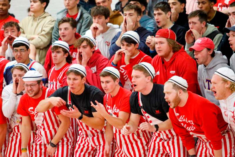 a group of people in red and white striped overalls