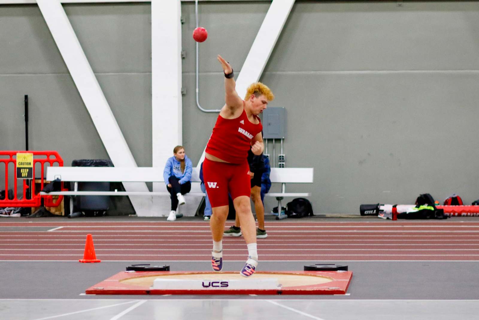 a man throwing a ball in a track