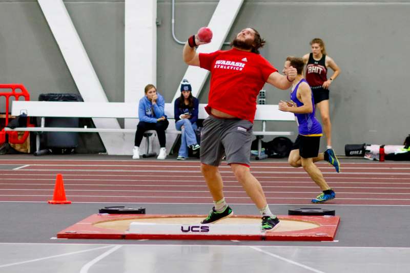 a man throwing a ball in a track