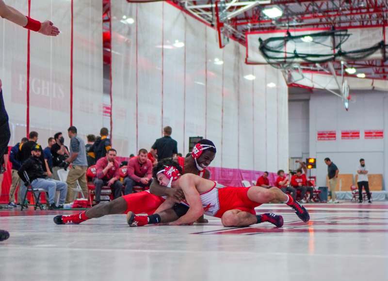 a group of people wrestling in a gym