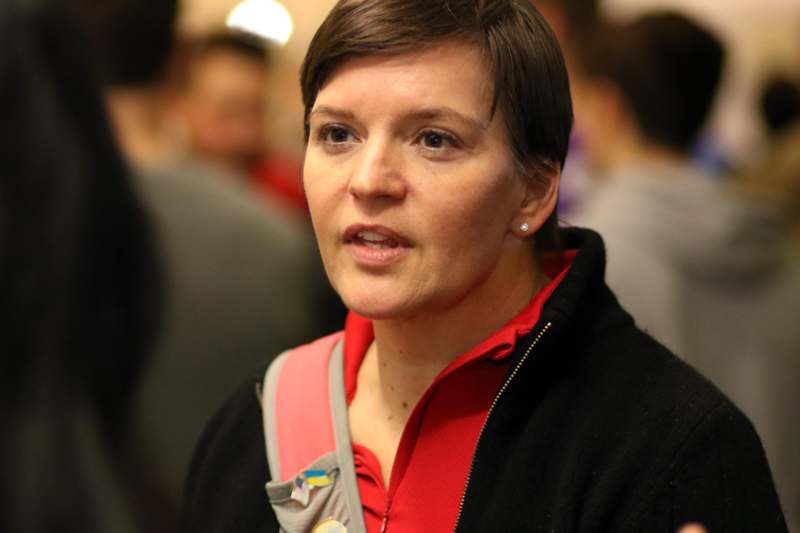 a woman with short hair wearing a black jacket