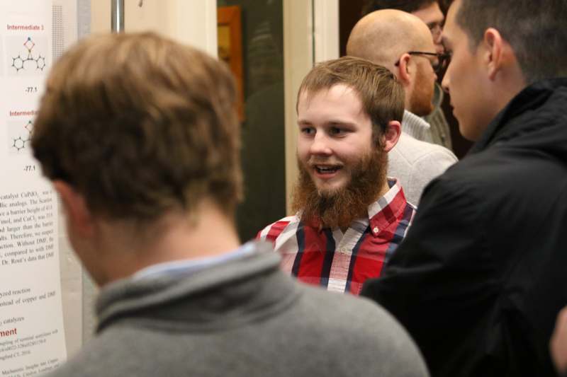 a man with a beard talking to a group of men