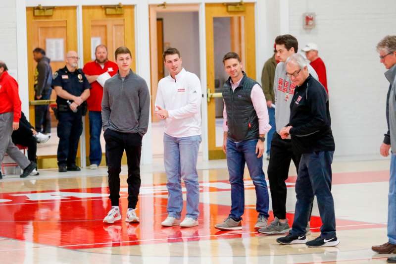 a group of men standing in a gym