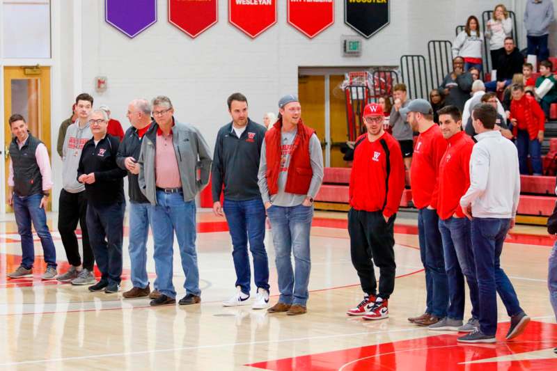 a group of men standing in a gym