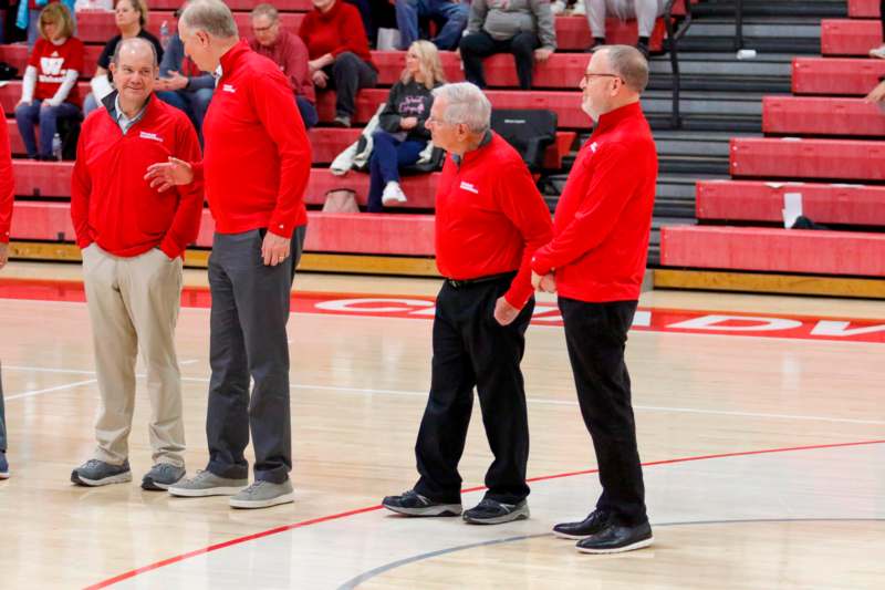 a group of men in red shirts