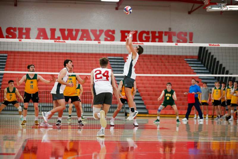 a group of people playing volleyball