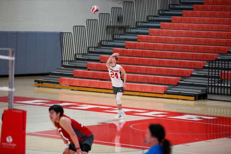 a man in a red uniform playing volleyball
