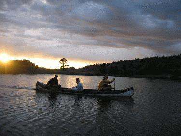 a group of people rowing a canoe