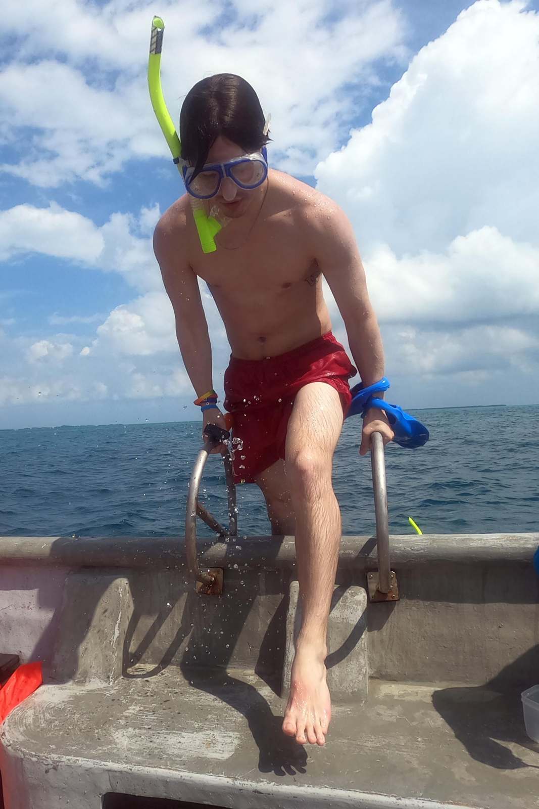 a man wearing snorkeling gear and goggles on a boat