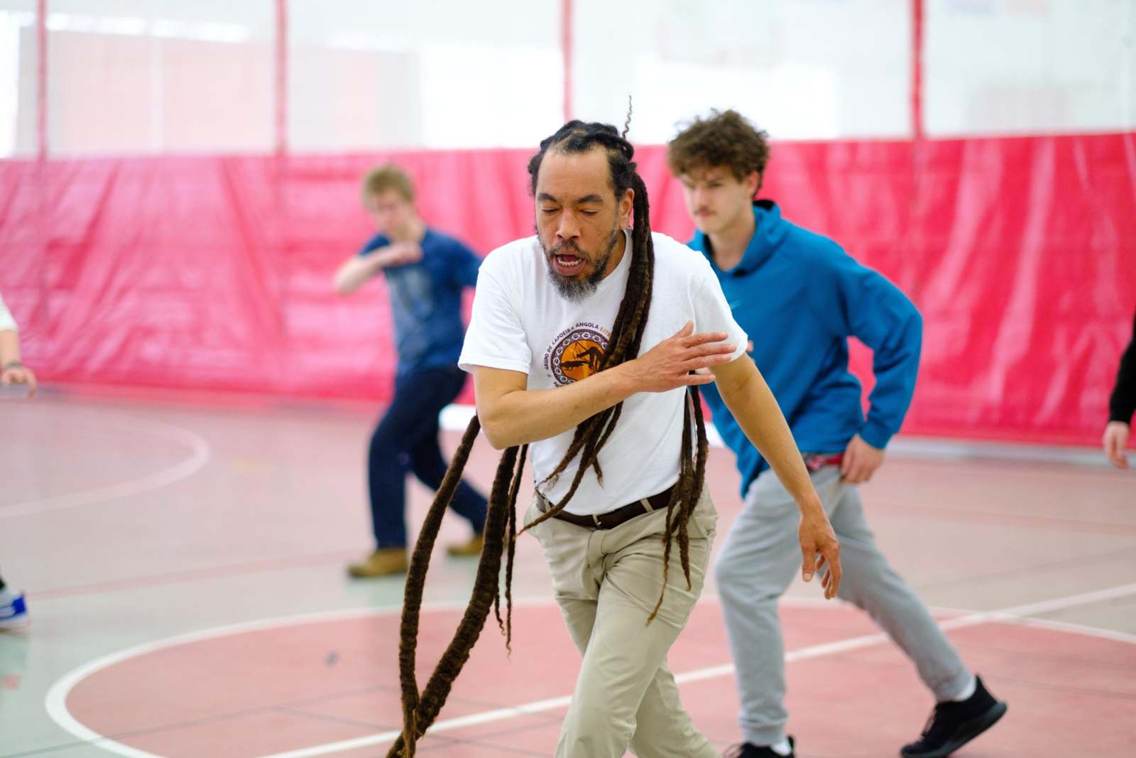 a man with long dreadlocks dancing on a court