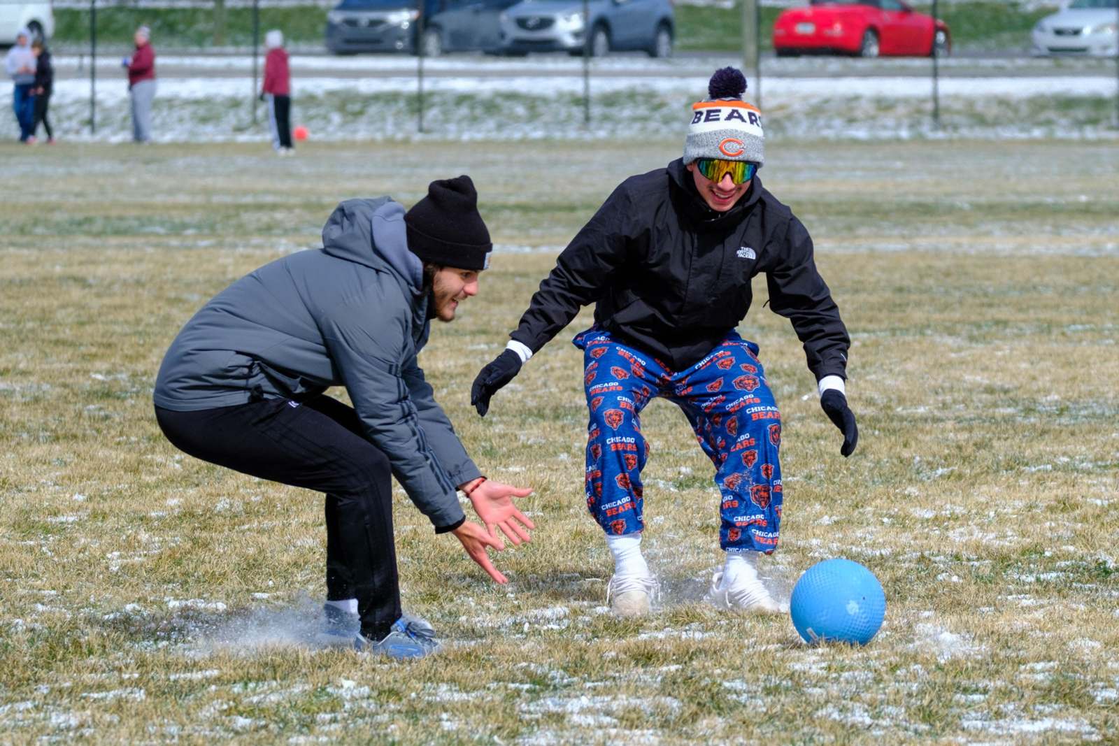 two people playing football in the snow