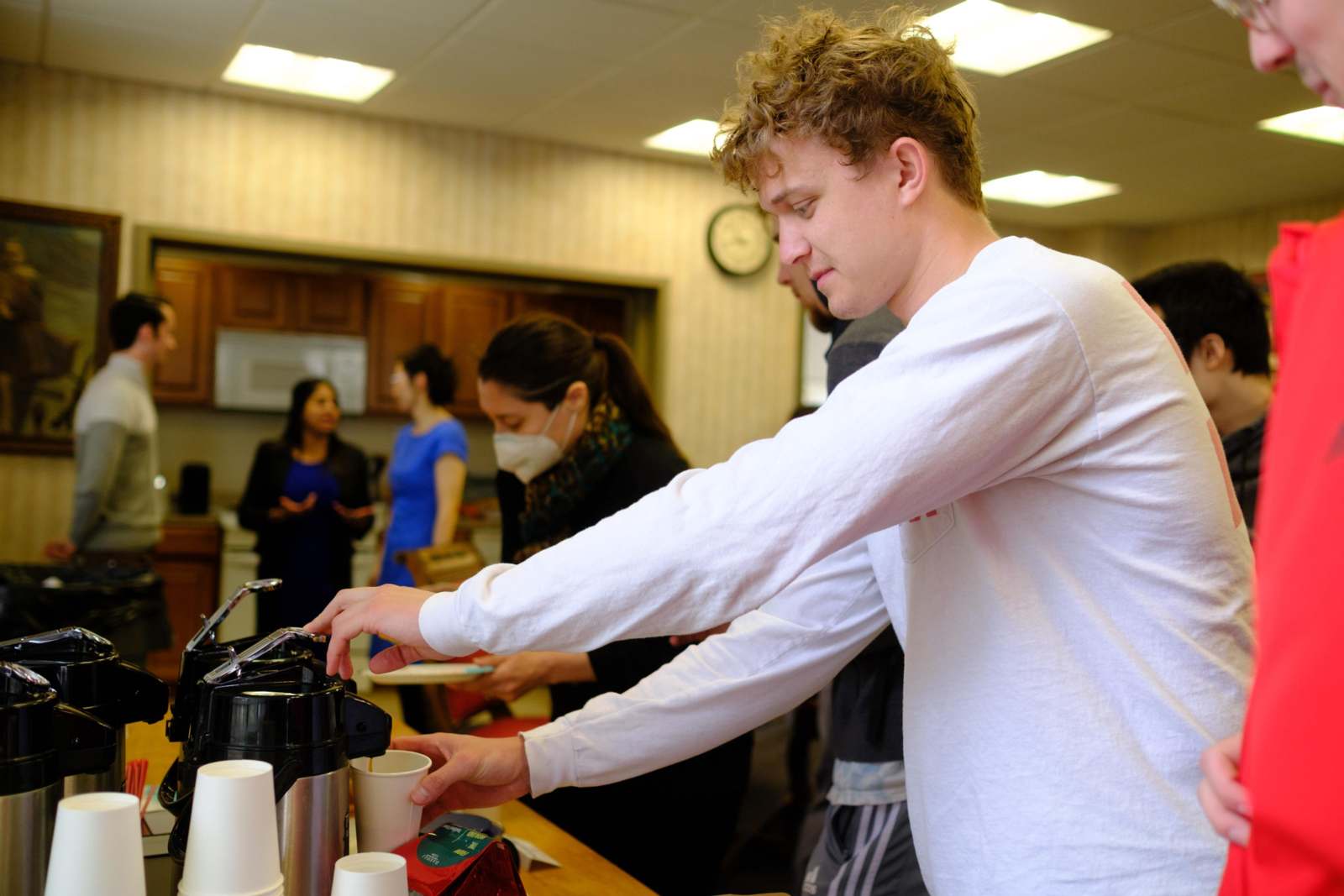 a man pouring coffee from a coffee machine