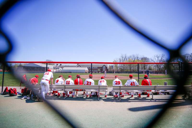 a group of baseball players sitting on a bench