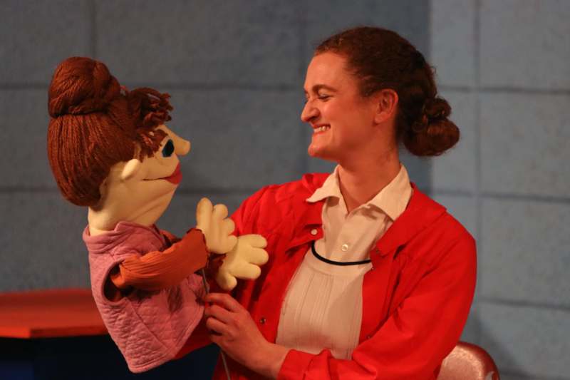 a woman holding a puppet