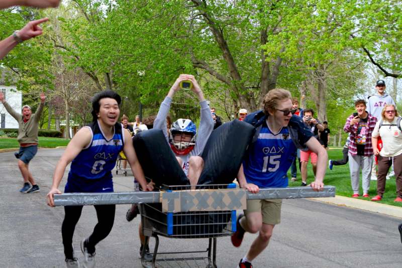 a group of people pushing a cart with a person pushing a cart