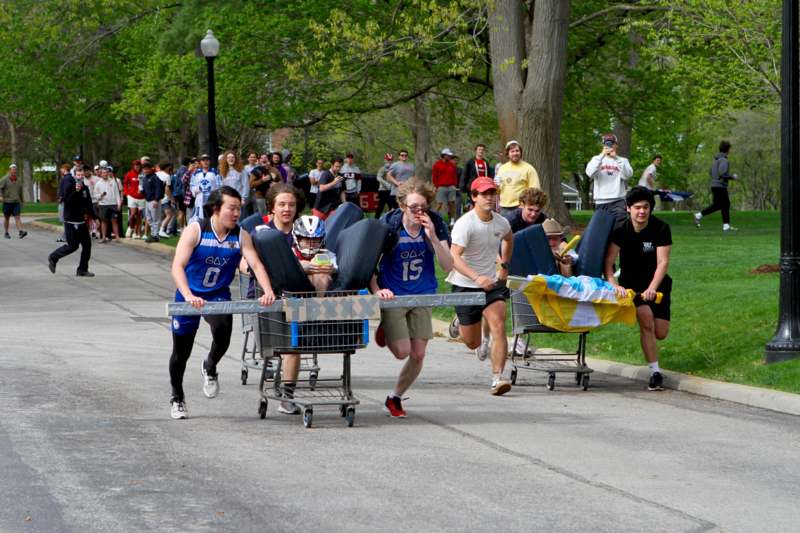 a group of people pushing shopping carts with people in the background