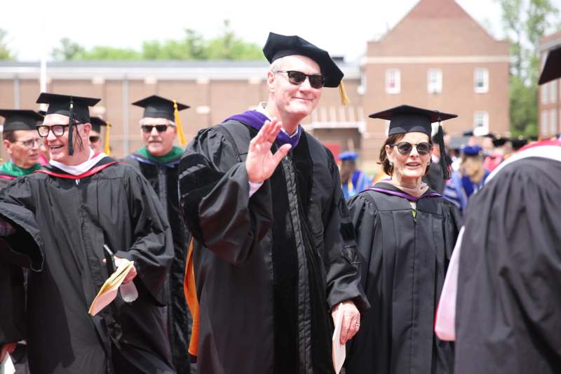 a group of people wearing graduation gowns and cap