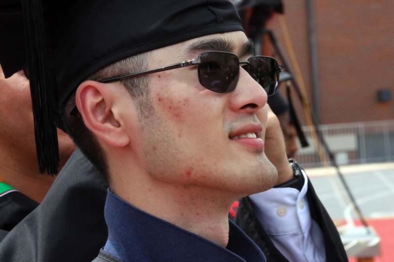 a man wearing sunglasses and a black hat