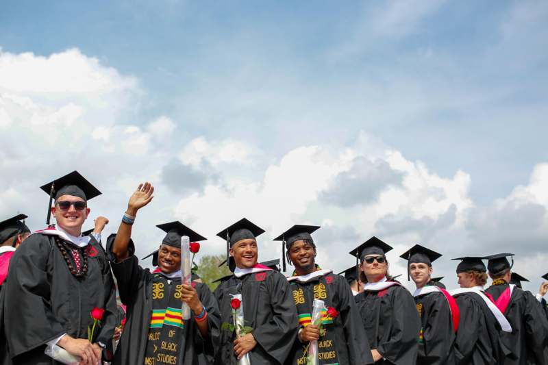 a group of graduates in graduation gowns and caps