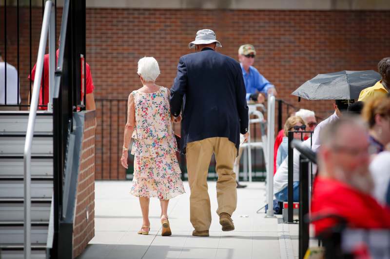 a man and woman walking down a sidewalk