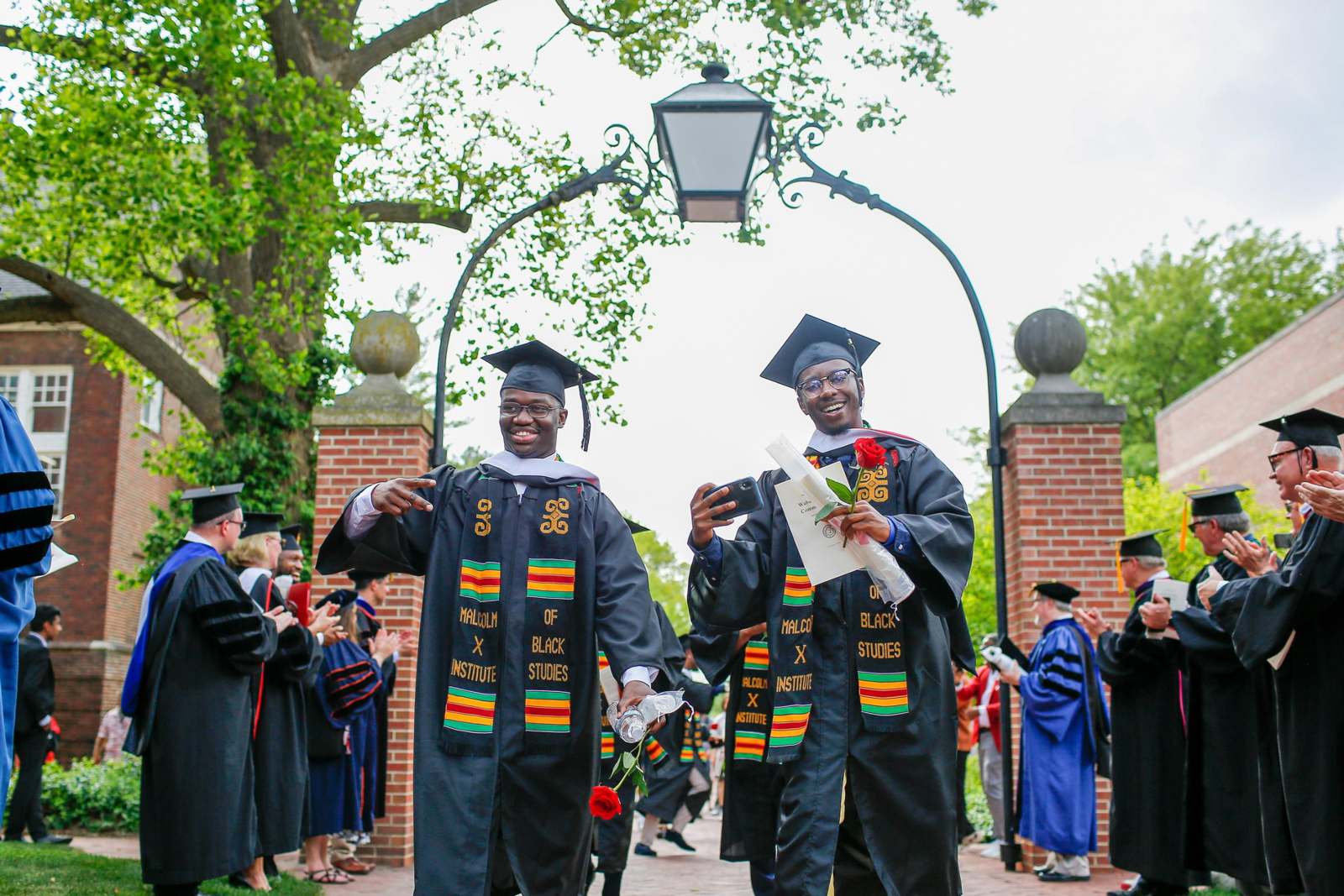 two men in graduation gowns and caps