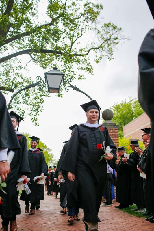 a group of people in graduation gowns and cap