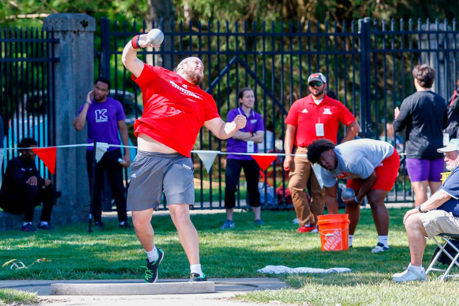 a man in red shirt throwing a ball