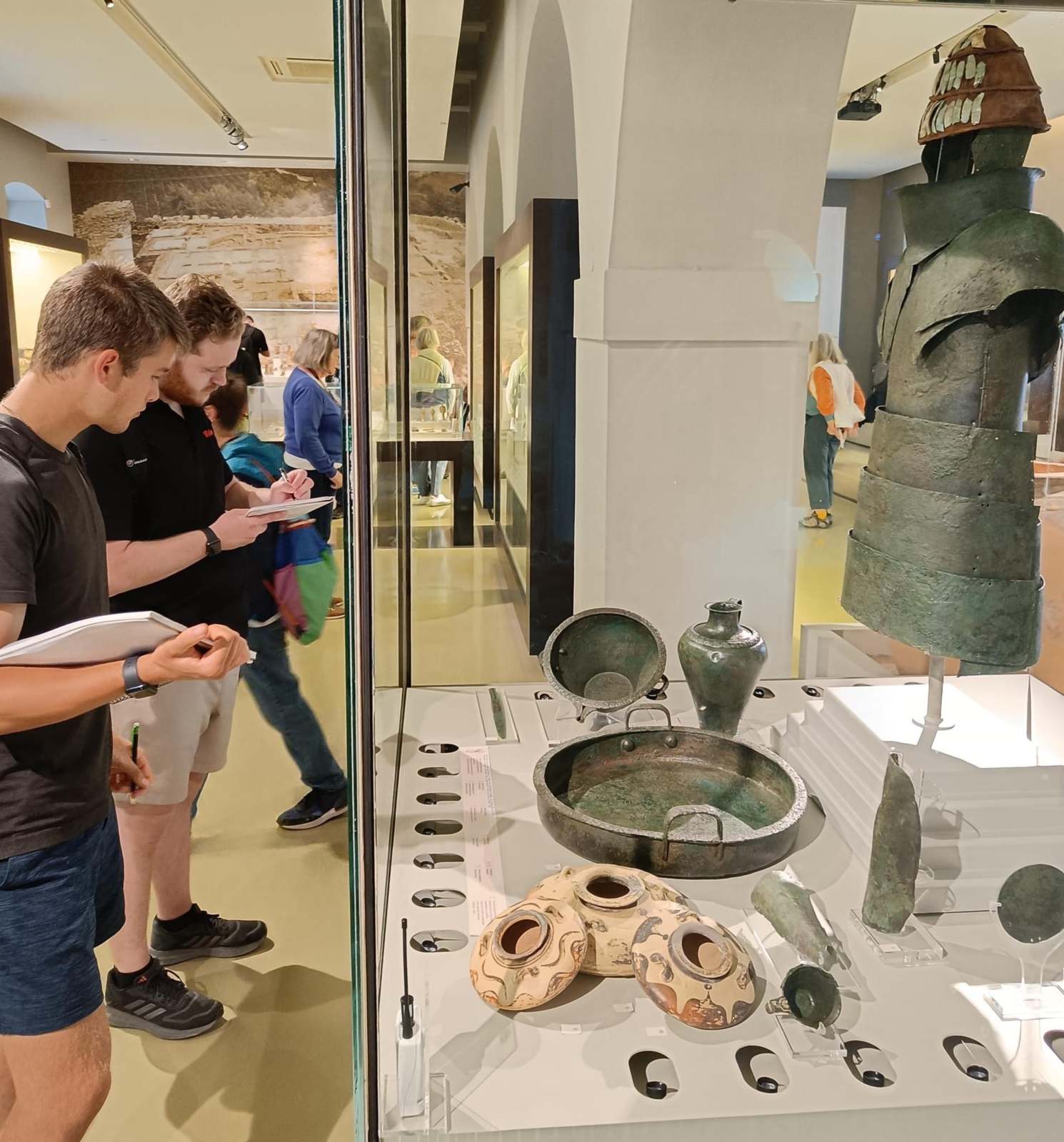 Students study the famous Dendra suit of armor in the archaeological museum in Nauplio