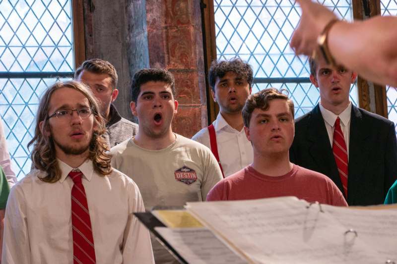 a group of men singing in a church