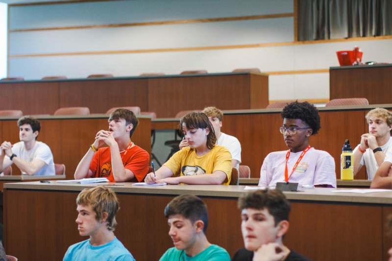 a group of people sitting in a lecture hall