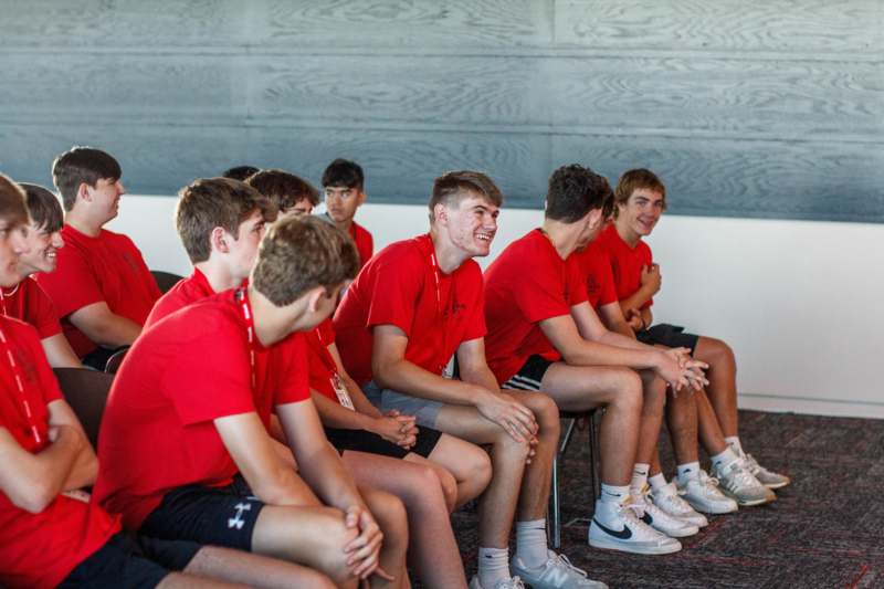 a group of boys sitting in a row