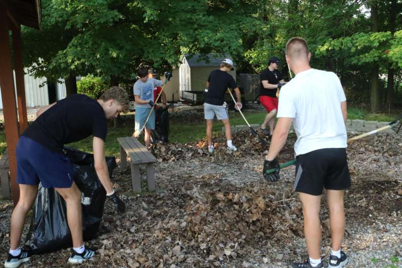 a group of people cleaning up a park