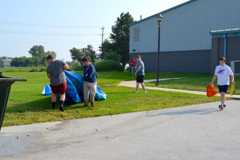 a group of people carrying a tent