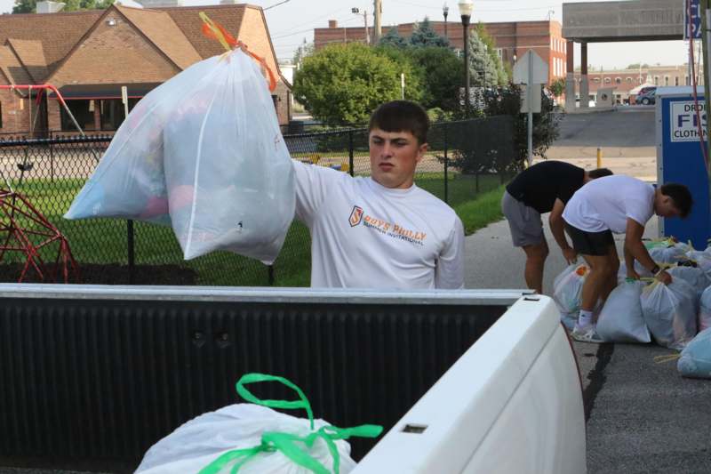 a man holding a bag of trash