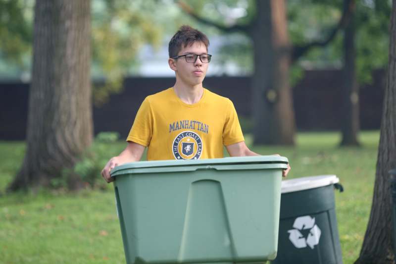 a boy standing in a trash can