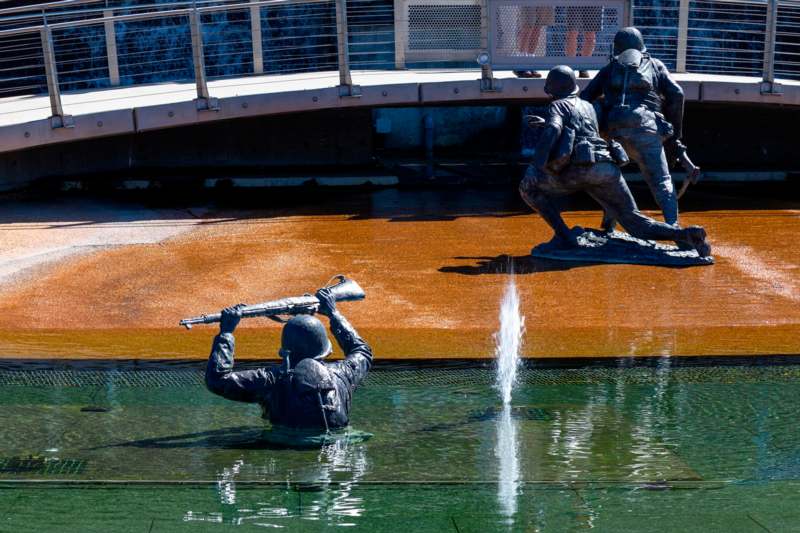 a statue of soldiers in water
