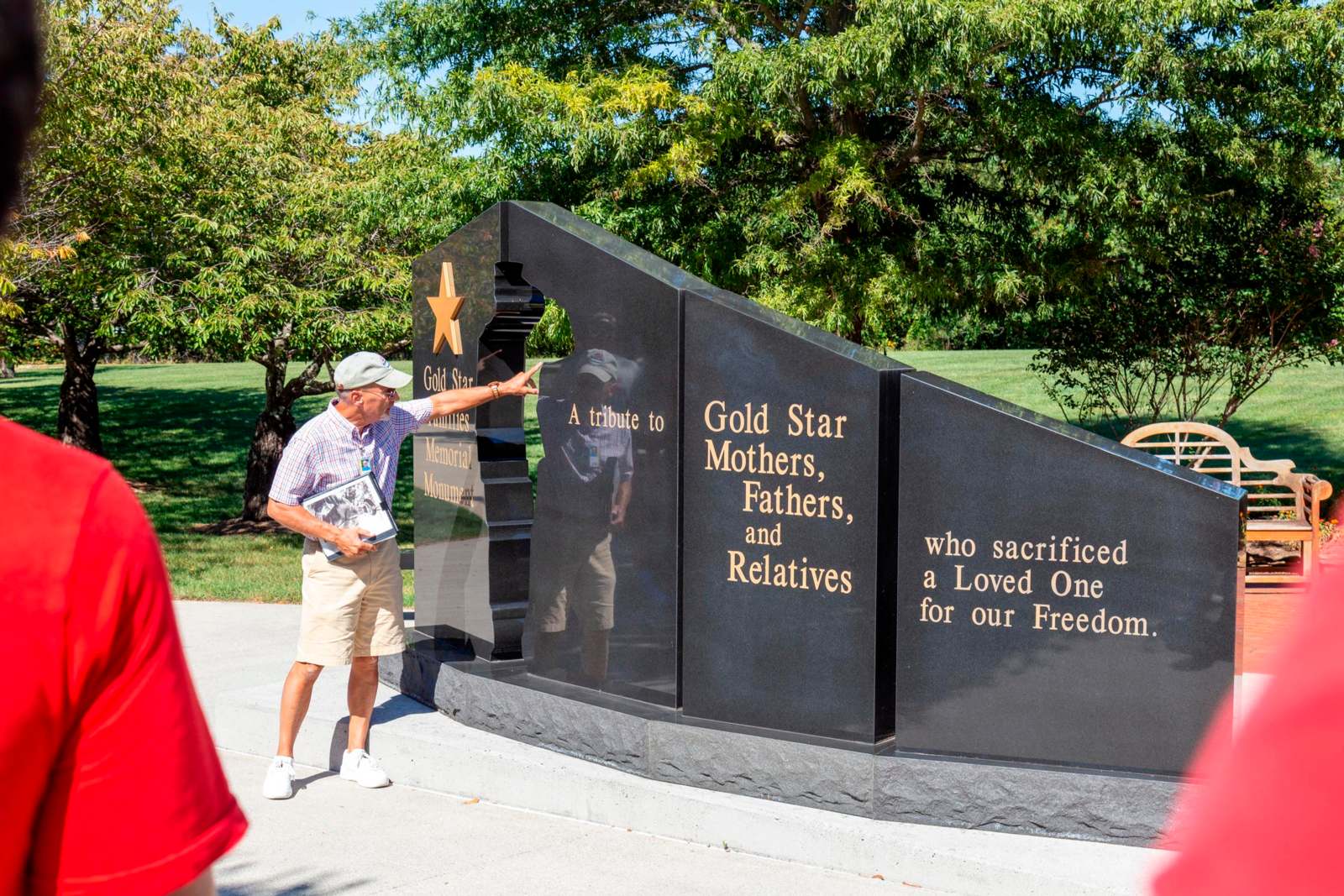 a man pointing at a memorial