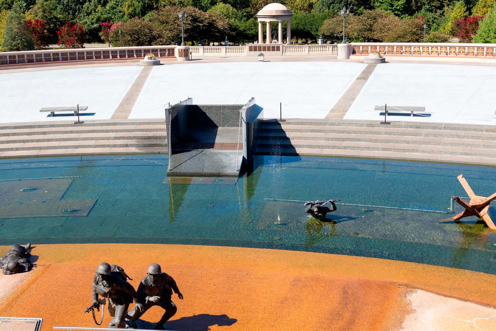 a statue of soldiers in a pool of water