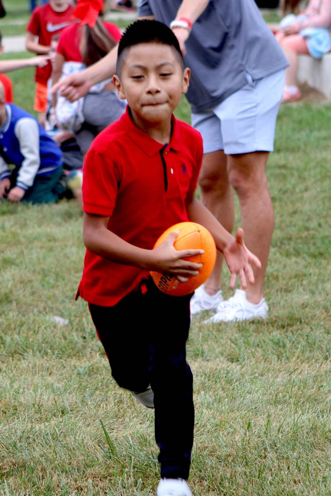a boy running with a ball