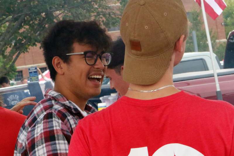 a man laughing with another man in the back